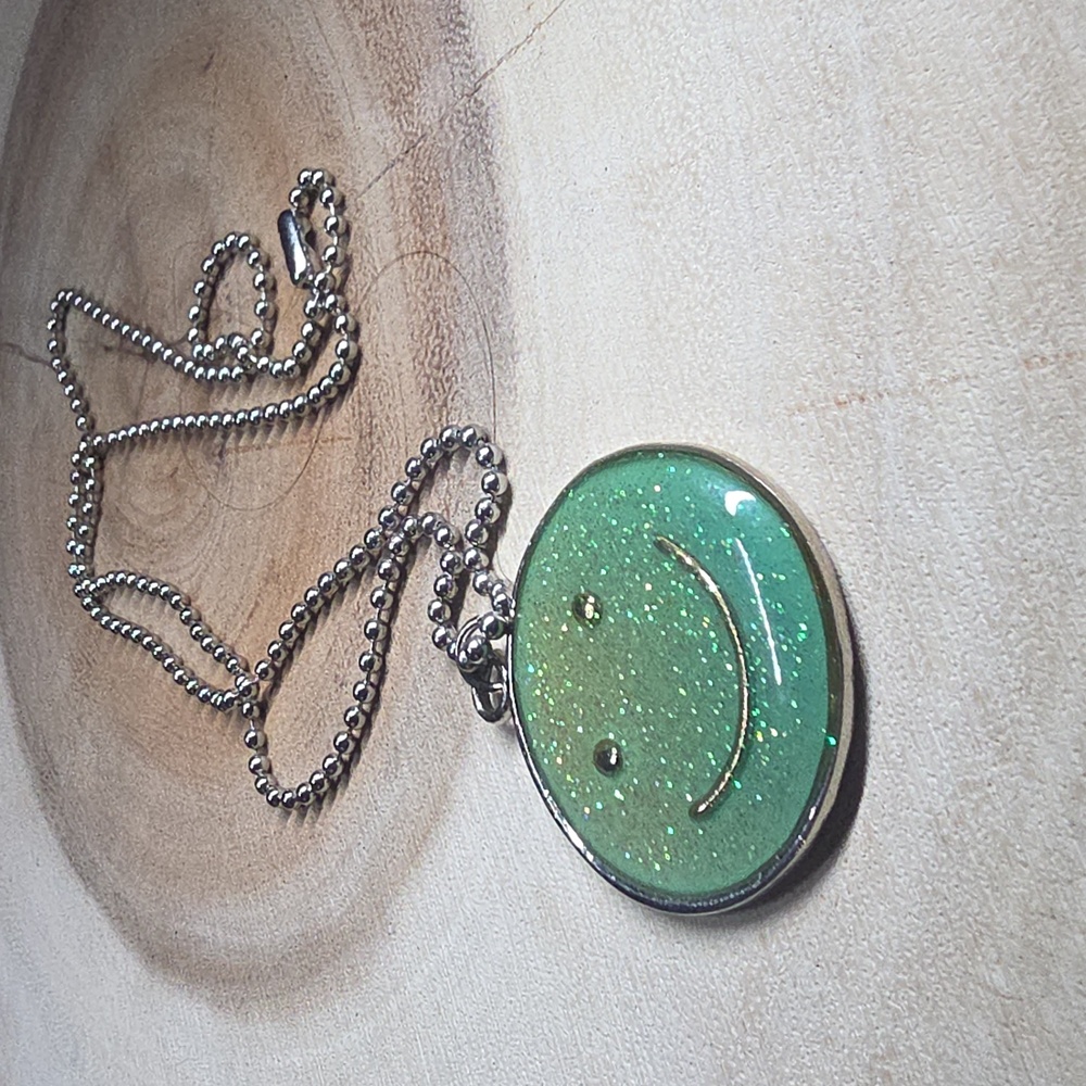 Glow In The Dark Green glitter smiley face resin pendant necklace.